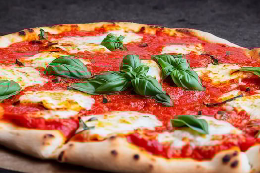 Italian pizza Margherita with tomato sauce Mozzarella cheese basil on a dark concrete background. Pizza recipe and menu. photo