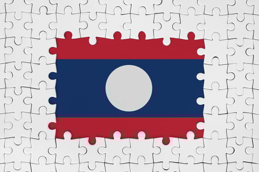 Laos flag in frame of white puzzle pieces with missing central part photo
