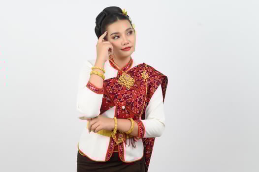 Young beautiful woman in Thai lanna costume with thoughtful posture photo