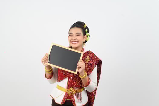 Portrait of Beautiful Thai Woman in Traditional Clothing Posing with blackboard photo