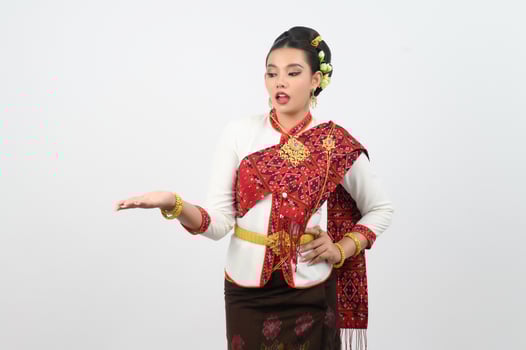 Young beautiful woman in northeastern dress stand and open palm posture photo