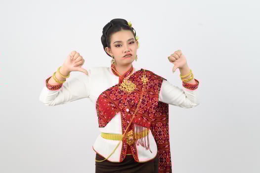Young beautiful woman in Thai lanna costume with thumb down posture photo