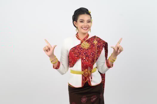 Young beautiful woman in northeastern dress stand and point finger posture photo