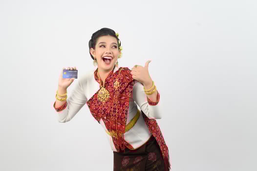 Young beautiful woman in northeastern dress show credit card posture photo