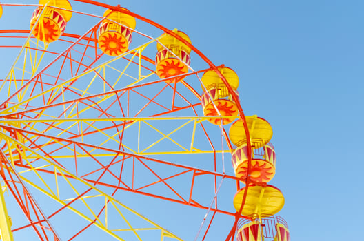 Ferris wheel on a background of blue clear sky photo