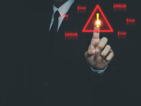 Businessman pressing or choosing Triangle warning sign for system error notification. Error notification abnormal system operation photo