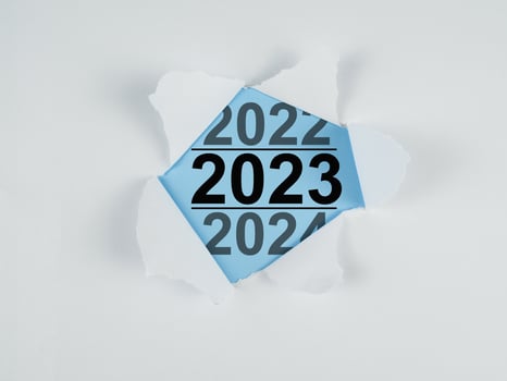 Torn paper with new year text 2023 on blue background. photo