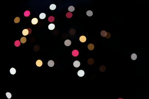 On a black background bokeh from explosions of colorful fireworks. photo