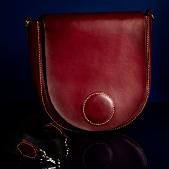 Leather red bag on a dark background. photo