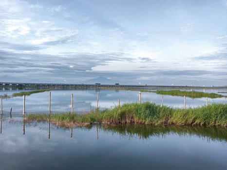 Big fish pond with blue sky background photo