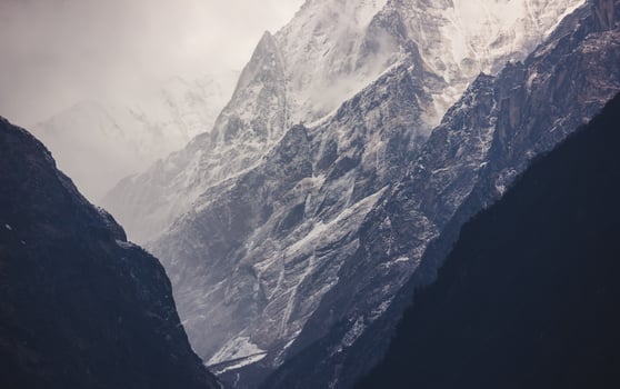 A dramatic landscape with the steep, icy, snow-covered ridges and ravines of the Annapurna mountains in the Nepal Himalayas. photo