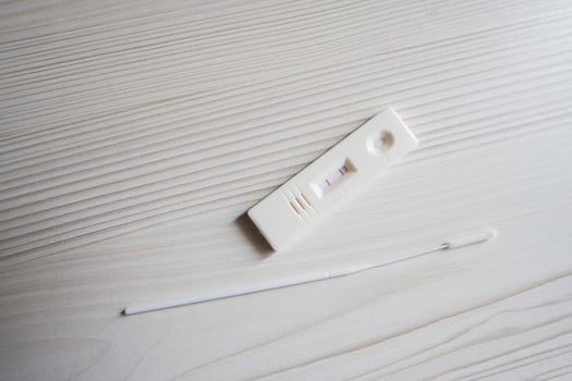 Positive SARS Covid antigen test kit, rapid test, saliva swab,  box with imagine of lungs. photo