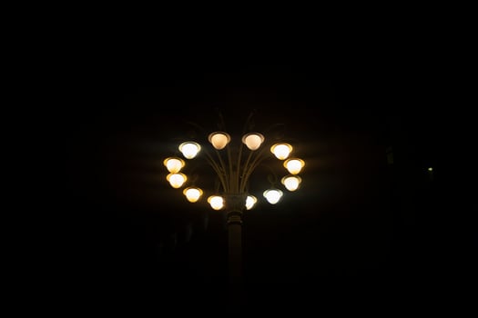High pole with spotlights at night. Stand with lamps. Lots of light sources. photo