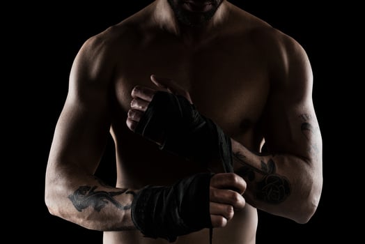 Boxer puts the tapes to his hands photo