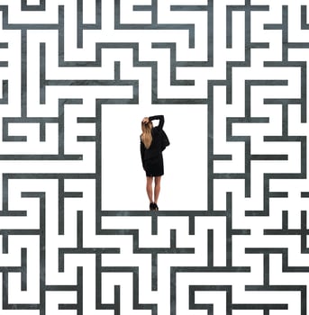 Confused businesswoman at the center of a maze photo
