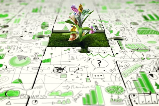 Plant with money grows from a missing piece of puzzle photo