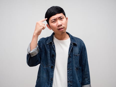 Negative asian man jeans shirt serious face gesture thinking isolated photo