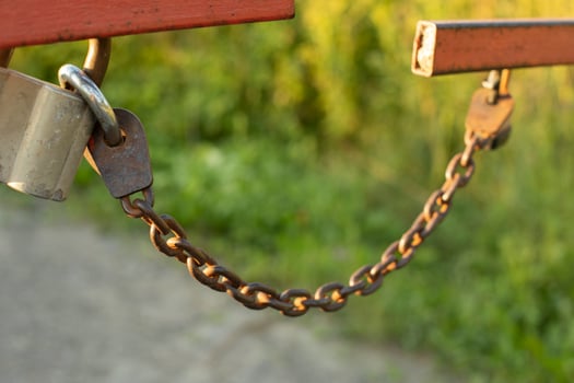 Chain on barrier. Fence on lock. Protection against travel. photo