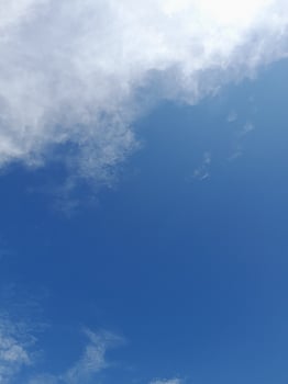 Beautiful white clouds on deep blue sky background. Large bright soft fluffy clouds are cover the entire blue sky. photo