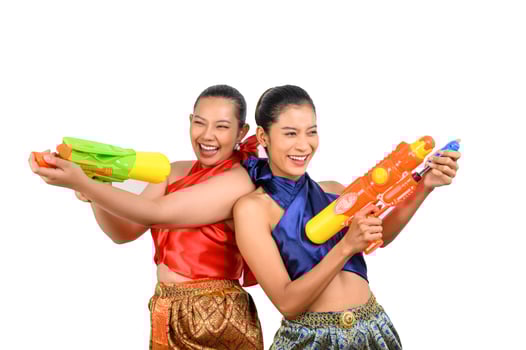 Two beautiful woman in Songkran festival with water gun photo