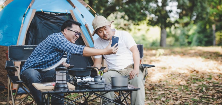 Portrait happy Asian man friends Making a video call with smartphone in camping photo