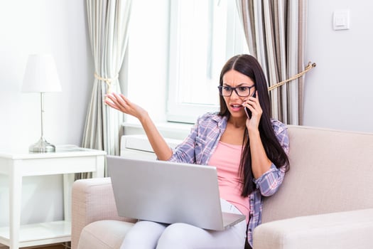 Confused customer calling support service at office. Outraged young female employee talking by phone. I don't want to hear excuses photo