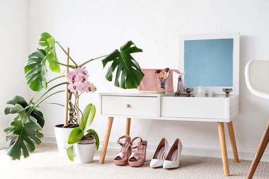 Stylish room interior with elegant dressing table and plants photo