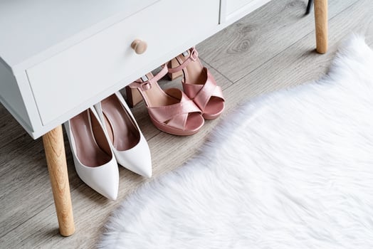 closeup of elegant high heel shoes standing under feminine dressing table photo