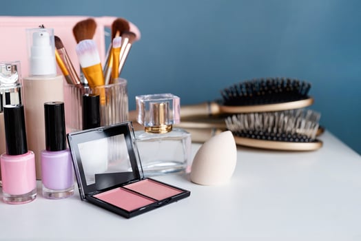 closeup of feminine cosmetic products standing on dressing table photo
