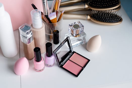closeup of feminine cosmetic products standing on dressing table photo