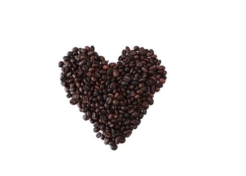 Dark Heath shaped soap bar on coffee beans close up isolated on white background photo