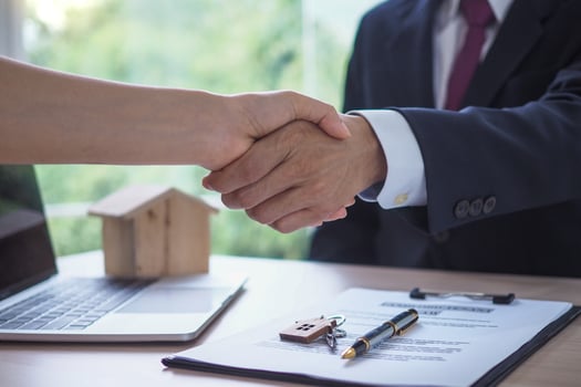 The salesperson shake hands with the landlord after negotiating a living agreement. photo