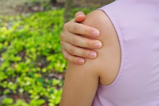 The girl has shoulder muscles pain. photo