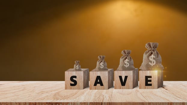 Wooden blocks with words save and money bag with Coins for investment loan planned future concept. saving, charity, family finance plan concept, fundraising, superannuation, financial crisis concept photo