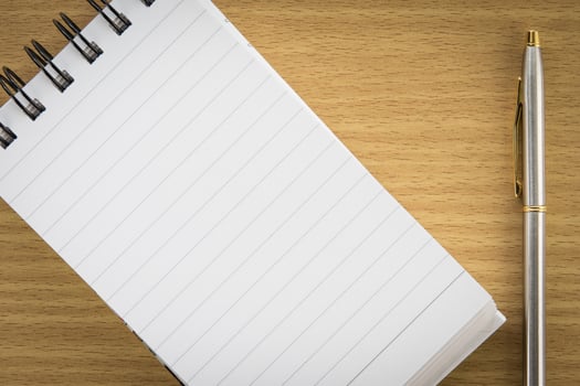 Pen and notepad with blank page photo