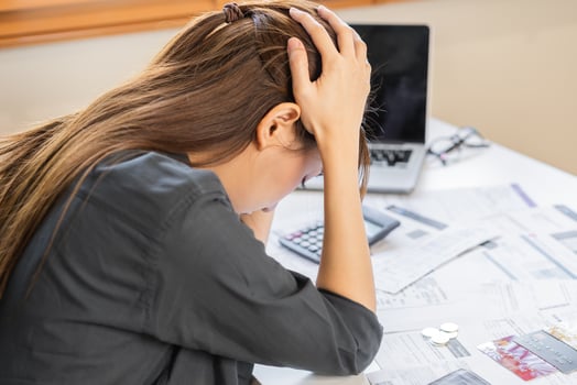 Financial owe asian woman sitting cover head with hands, stressed by calculate expense from invoice or bill, have no money to pay, mortgage or loan. Debt, bankruptcy or bankrupt concept. photo