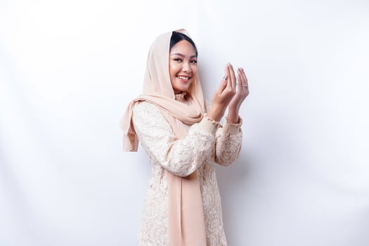 Religious beautiful Asian Muslim girl wearing a headscarf praying to God. photo