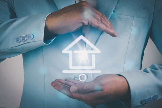 Business man hand covering house icon. photo