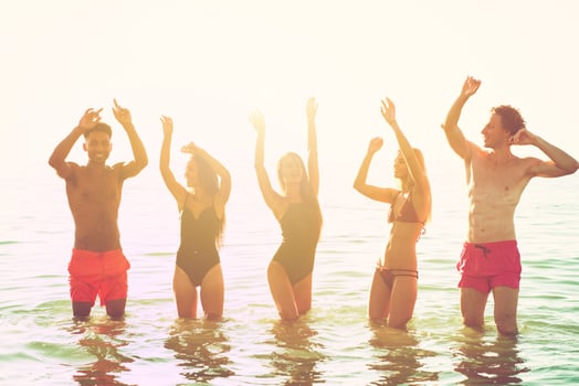 Group of friends dancing on the beach photo