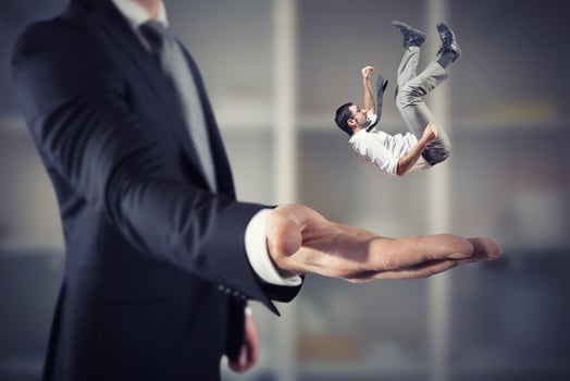 Businessman is saved from a big hand. Concept of business support and assistance photo