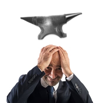 Difficult career in business with falling anvil photo