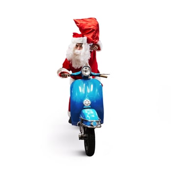 Santa Claus with red bag of presents on a motorcycle to deliver presents photo