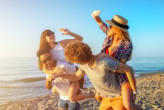 Happy smiling couples playing at the beach photo