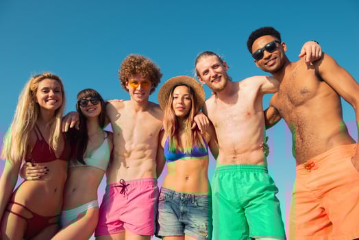 Group of friends having fun on the beach. Concept of summertime photo