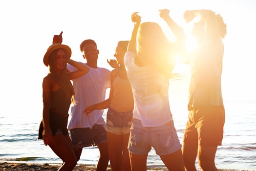 Group of friends dancing on the beach photo