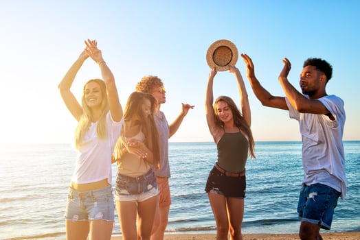 Group of friends dancing on the beach photo