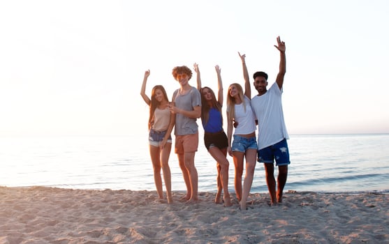 Group of friends having fun on the beach. Concept of summertime photo