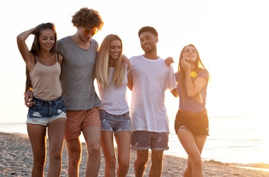Group of friends having fun on the beach. Concept of summertime photo