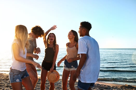 Group of friends dancing on the beach photo
