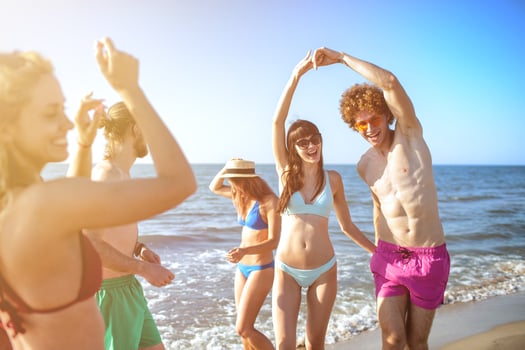 Group of friends dancing on the beach photo